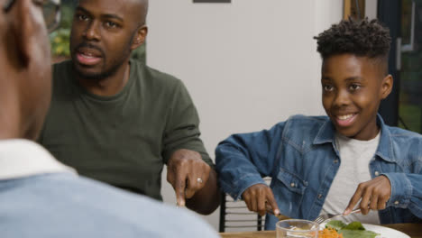 Father-Son-and-Grandfather-Talking-During-Evening-Dinner