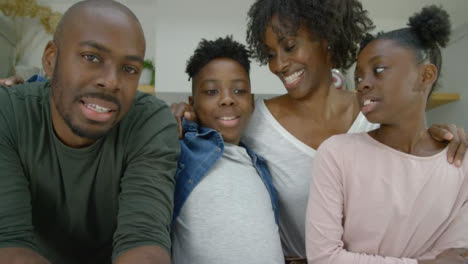 Mother-and-Father-with-Two-Young-Children-Talking-Directly-into-Webcam-During-Video-Call