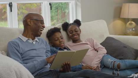 Grandfather-Reading-Story-Book-to-Grandchildren