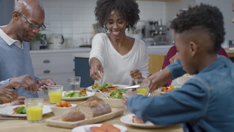 Family-Begin-Plating-Up-and-Eating-Dinner-Together-