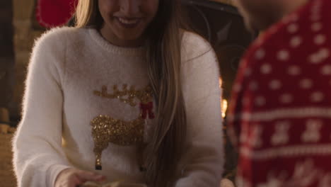 Close-Up-Shot-of-Young-Woman-Opening-a-Christmas-Gift-From-Boyfriend