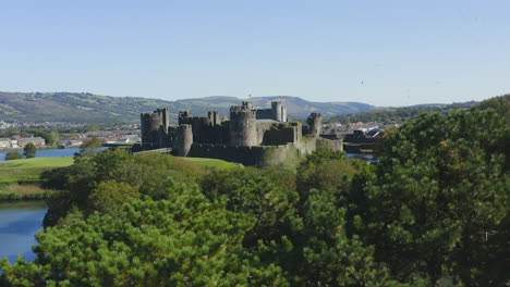 Drone-Shot-Rising-Over-Trees-Revealing-Caerphilly-Castle-05