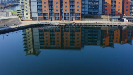 Drone-Shot-Orbiting-Apartment-Building-Reflection-On-Swansea-Marina-01