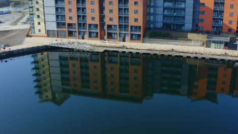 Drone-Shot-Orbiting-Apartment-Building-Reflection-On-Swansea-Marina-02