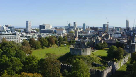 Drone-Shot-Rising-Above-Trees-Revealing-Cardiff-Castle-01