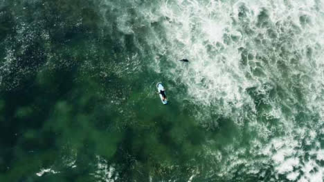 Rotating-Drone-Shot-Looking-Down-On-People-In-Ocean-Off-of-Canggu-Coast