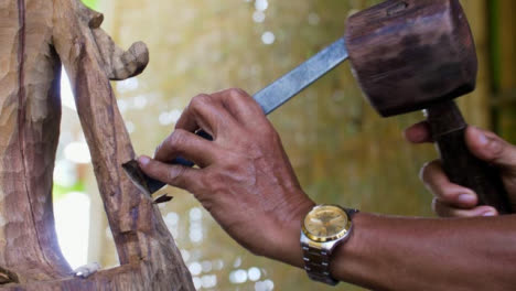 Handheld-Close-Up-Shot-of-Wood-Carvers-Hands-Using-Chisel-