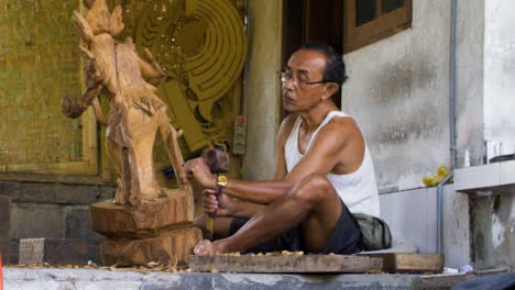 Handheld-Wide-Shot-of-Wood-Carver-Creating-Sculpture