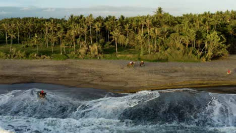 Drone-Shot-Descending-On-Horse-Riders-On-Pigstone-Beach-