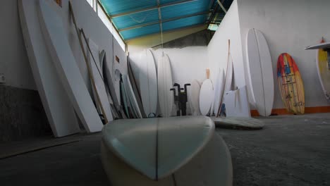 Handheld-Sliding-Low-Angle-Shot-of-Surfboard-Workshop