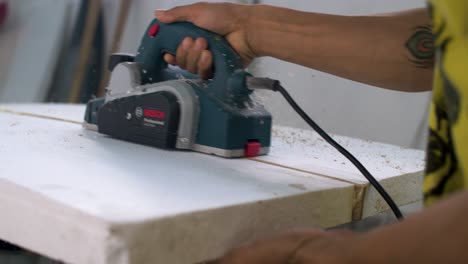 Handheld-Close-Up-Shot-of-Surfboard-Shaper-Crafting-Surfboard