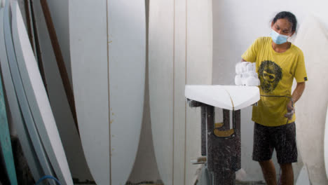 Handheld-Wide-Shot-of-a-Surfboard-Shaper-Using-a-Power-Tool