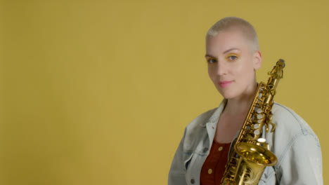 Portrait-Shot-of-Model-Smiling-to-Camera-Whilst-Holding-Saxophone