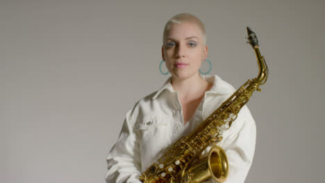 Portrait-Shot-of-Female-Model-Posing-to-Camera-Whilst-Holding-Saxophone
