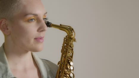 Close-Up-Shot-of-a-Model-Posing-with-Saxophone