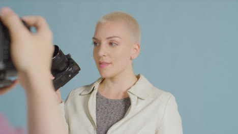 BTS-footage-of-female-caucasian-photographer-posing-with-DSLR