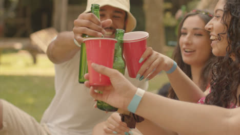 Tracking-Shot-of-Young-Festival-Goers-Bringing-Their-Drinks-Together