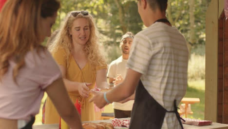 Long-Shot-of-Festival-Goer-Getting-Hot-Dog-from-Fast-Food-Stand