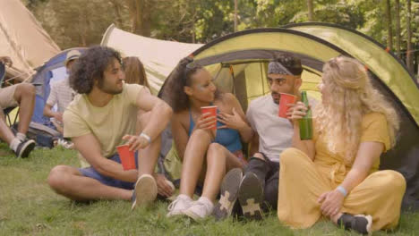 Wide-Shot-of-Festival-Goers-Drinking-and-Talking-by-Their-Tent