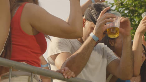 Low-Angle-Shot-of-Young-Festival-Goers-Enjoying-Music-at-Stage-Barrier