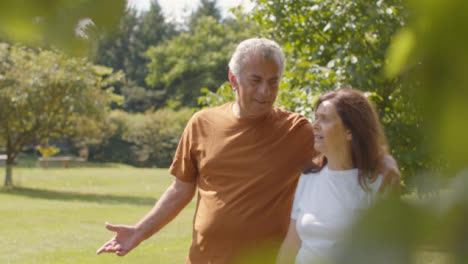 Tracking-Shot-of-Senior-Couple-Walking-Through-Lush-Gardens-03