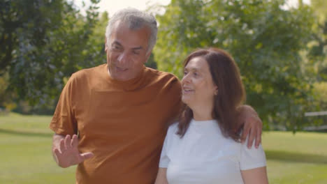 Tracking-Shot-of-Senior-Couple-Walking-Through-Lush-Gardens-04