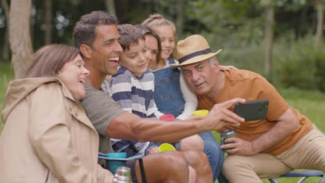 Medium-Shot-of-Family-Taking-a--Selfie-On-Camping-Trip-01