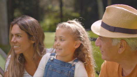 Tracking-Shot-of-Family-On-Camping-Trip-Sitting-and-Talking-by-Their-Tents-07