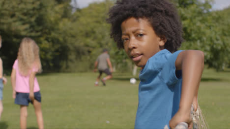 Over-the-Shoulder-Shot-of-Group-of-Children-Playing-Football