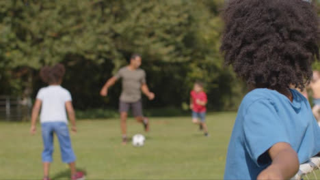 Over-the-Shoulder-Shot-of-a-Group-of-Children-Playing-Football-01