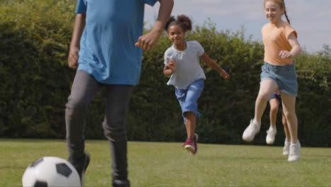 Tracking-Shot-of-Group-of-Children-Playing-Football-02