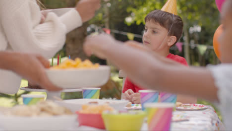 Tracking-Shot-of-Children-Sitting-at-Table-at-Outdoor-Birthday-Party-03