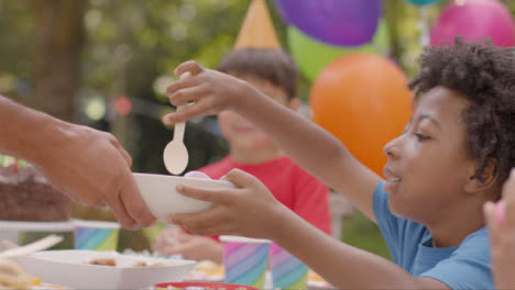 Close-Up-Shot-of-Children-Sitting-at-Table-at-Outdoor-Birthday-Party-01