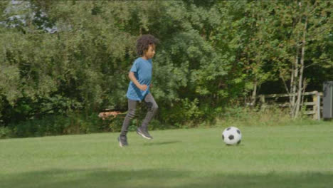 Panning-Shot-of-Children-Playing-Football