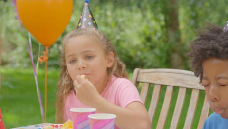 Over-the-Shoulder-Shot-of-Child-Enjoying-Food-at-Birthday-Party