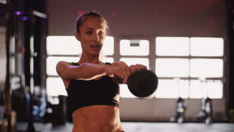 Slow-Motion-Of-Sporty-Young-Woman-Exercising-With-Kettlebell-During-Fitness-Training