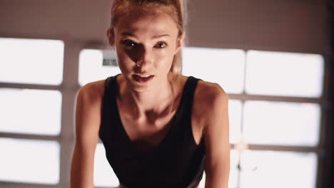 Slow-Motion-Of-Determined-Young-Woman-Cycling-On-Stationary-Bike-At-Gym