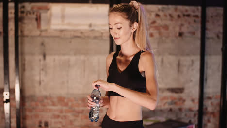 Slow-Motion-Of-Young-Athletic-Woman-Drinking-Water-From-Bottle-At-Health-Club