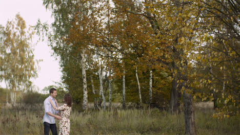 Couple-Hugging-And-Walking-On-A-Meadow-In-Summer-At-Sunset-5