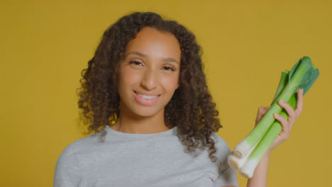 Portrait-Shot-of-Young-Adult-Woman-Holding-Leeks