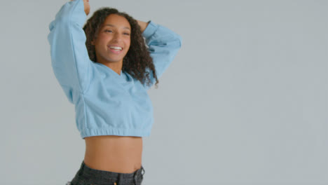 Tracking-Shot-of-Young-Adult-Woman-Smiling-and-Dancing-