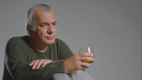Close-Up-Shot-of-Senior-Man-Drinking-Alcohol-