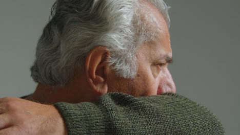 Tracking-Shot-Orbiting-a-Senior-Man-Coughing-into-His-Elbow