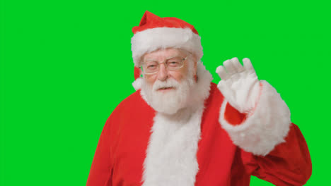 Portrait-Shot-of-Santa-Waving-Hello-to-Camera-with-Green-Screen