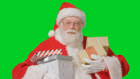 Portrait-Shot-of-Santa-Holding-Presents-In-Front-of-a-Green-Screen