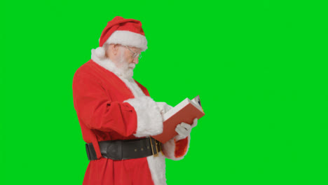 Portrait-Shot-of-Santa-Holding-Reading-Through-Big-Red-Book