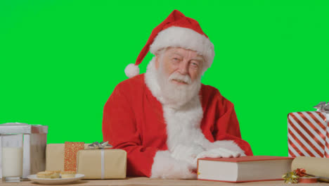 Portrait-Shot-of-Santa-Talking-to-Camera-In-Front-of-Green-Screen-