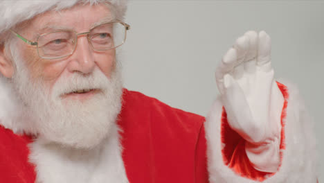 Close-Up-Shot-of-Santa-Claus-Waving-and-Looking-Off-Camera