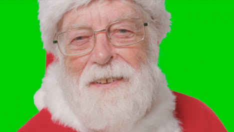 Close-Up-Shot-of-Santa-Looking-Into-Camera-In-Front-of-Green-Screen