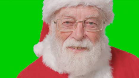 Close-Up-Shot-of-Santa-Smiling-to-Camera-In-Front-of-Green-Screen